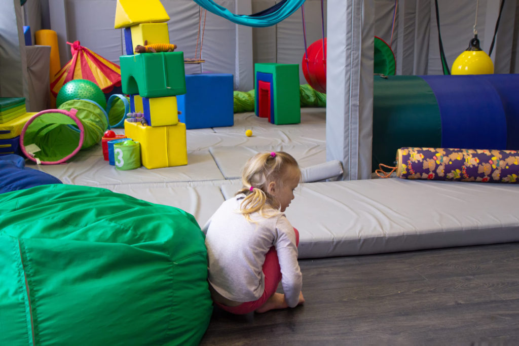 Little,Girl,Plays,In,A,Sensory,Integration,Room,On,Floor